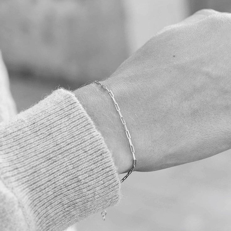 Close up of female model wearing 925 sterling silver chain bracelet