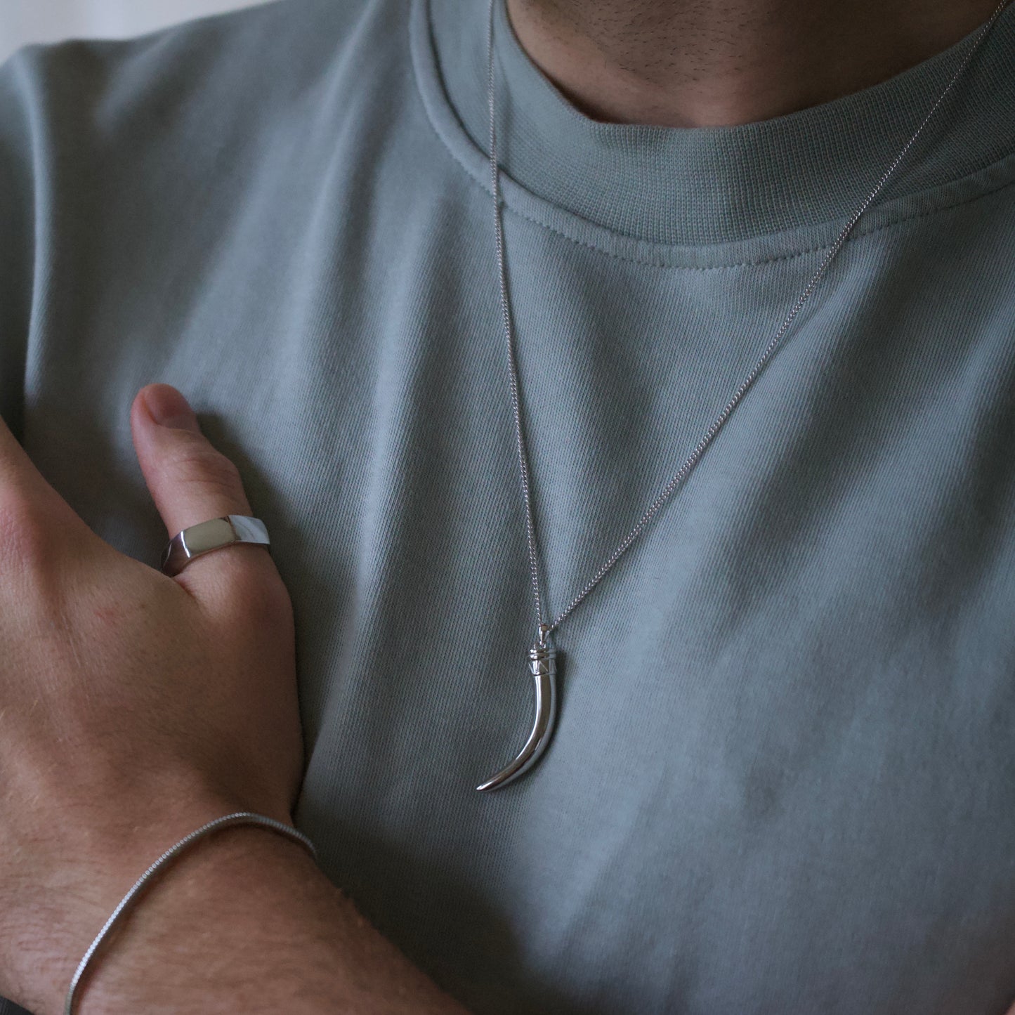 Model Wearing 925 sterling silver horn necklace and silver bolt ring