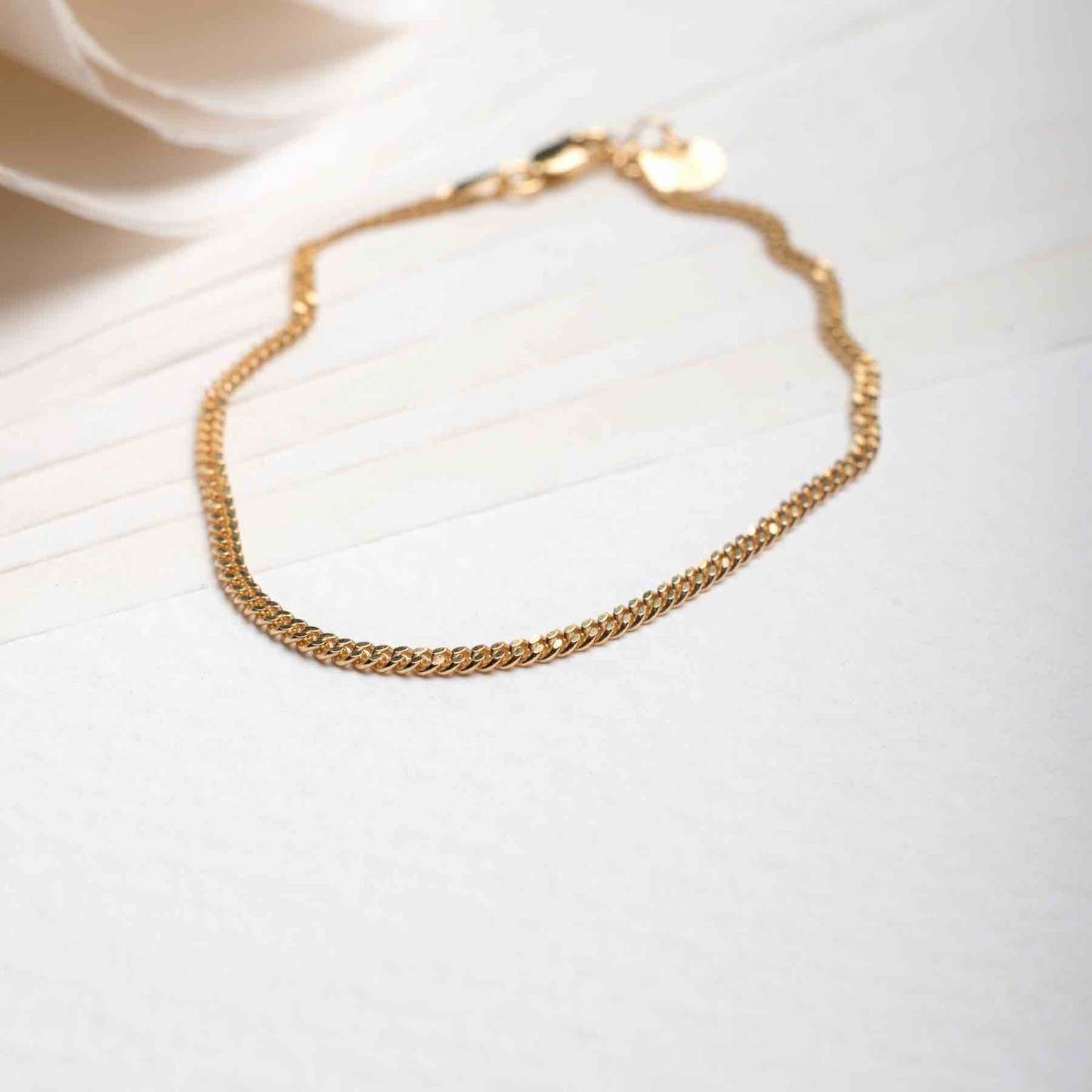 18k gold plated men's bracelet displayed on a table