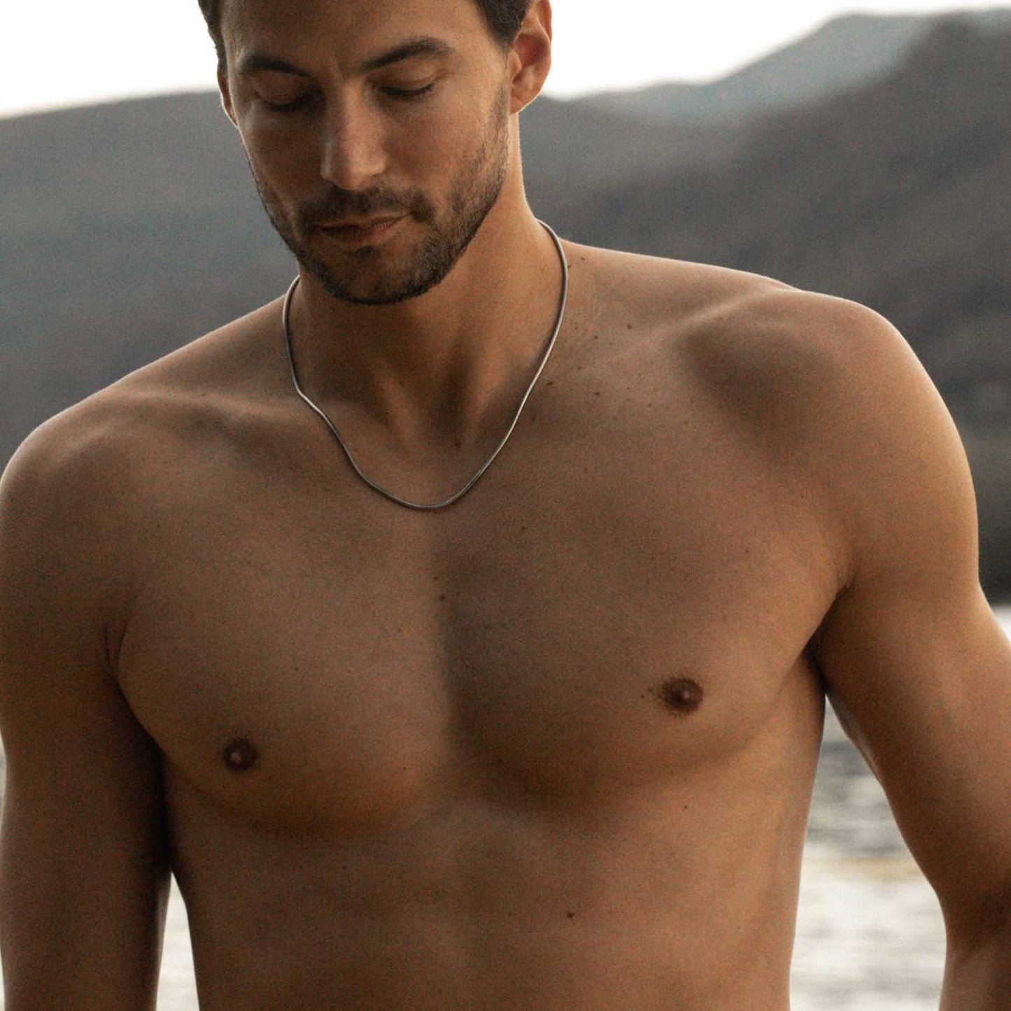man modelling a 925 sterling silver mamba necklace