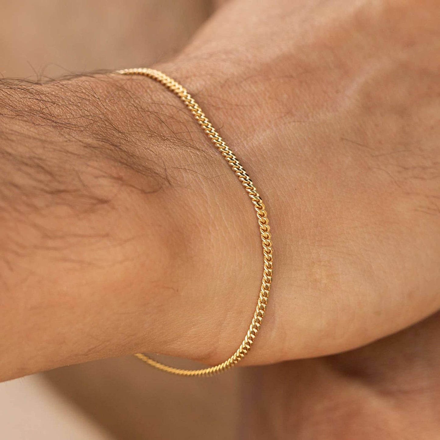 Man wearing a 18k gold plated bracelet