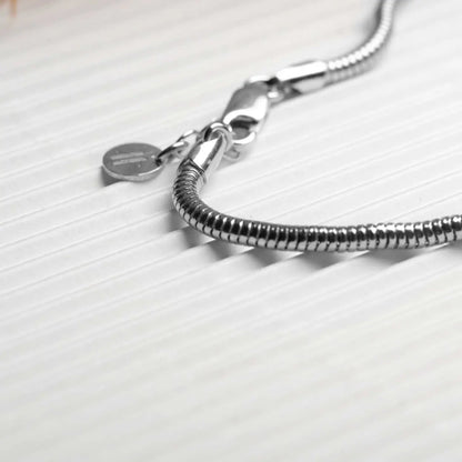 Men's 925 sterling silver mamba bracelet on displayed on a white table