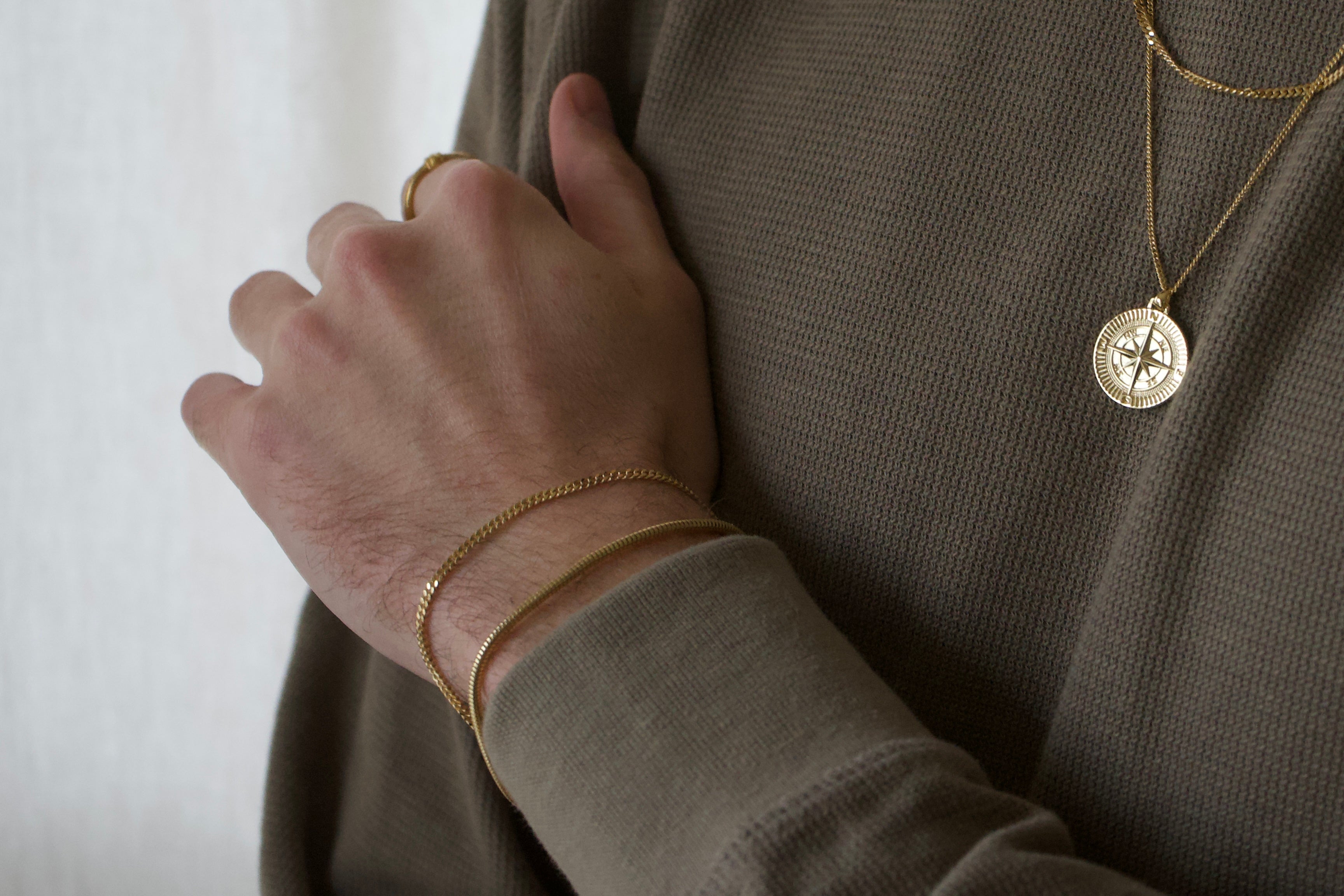 Model wearing men's 18k gold plated bracelets