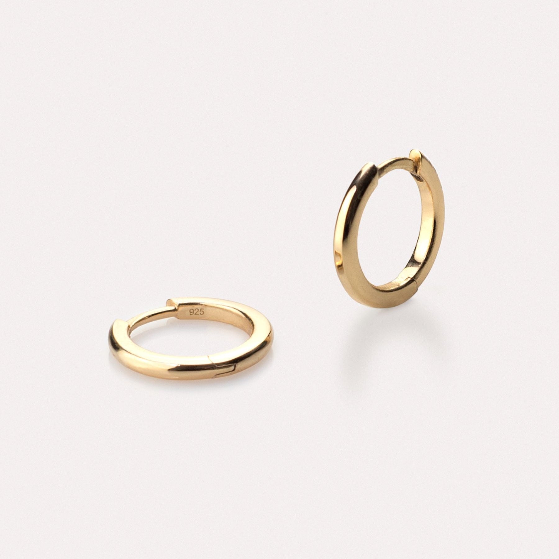 Pair of 18k gold-plated hoop earrings on a white background