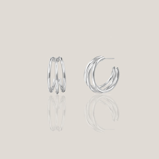 Pair of 925 sterling silver triple hoop earrings on a light grey background