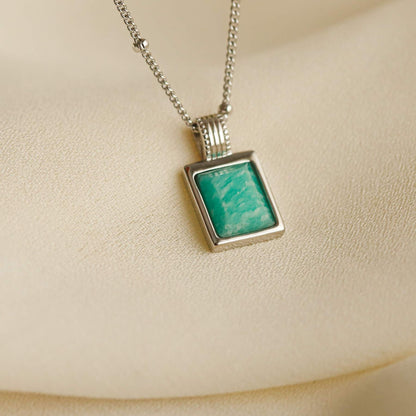 Women's 925 sterling silver necklace with blue amazonite stone pendant on a beige background
