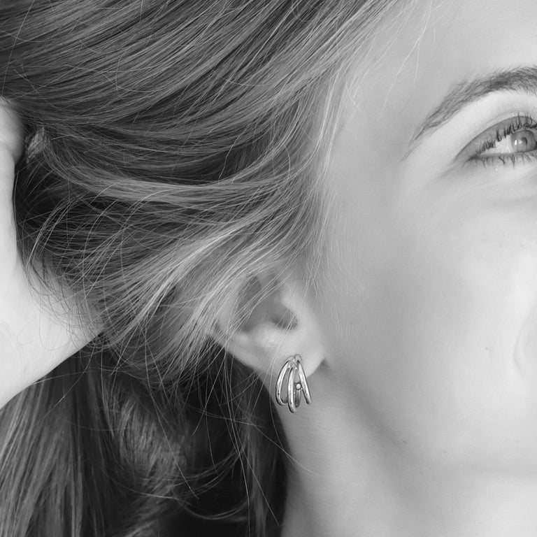 Women wearing a pair of 925 sterling silver triple hoop earrings