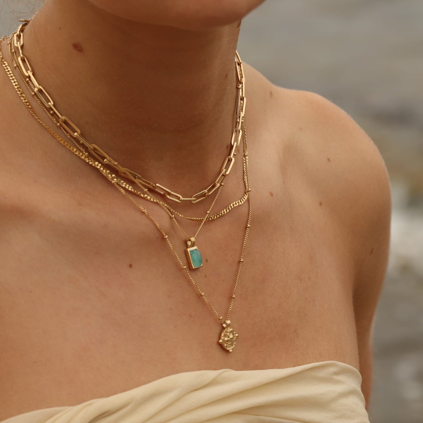 Women wearing 18k gold-plated necklace with a square amazonite blue gemstone pendant