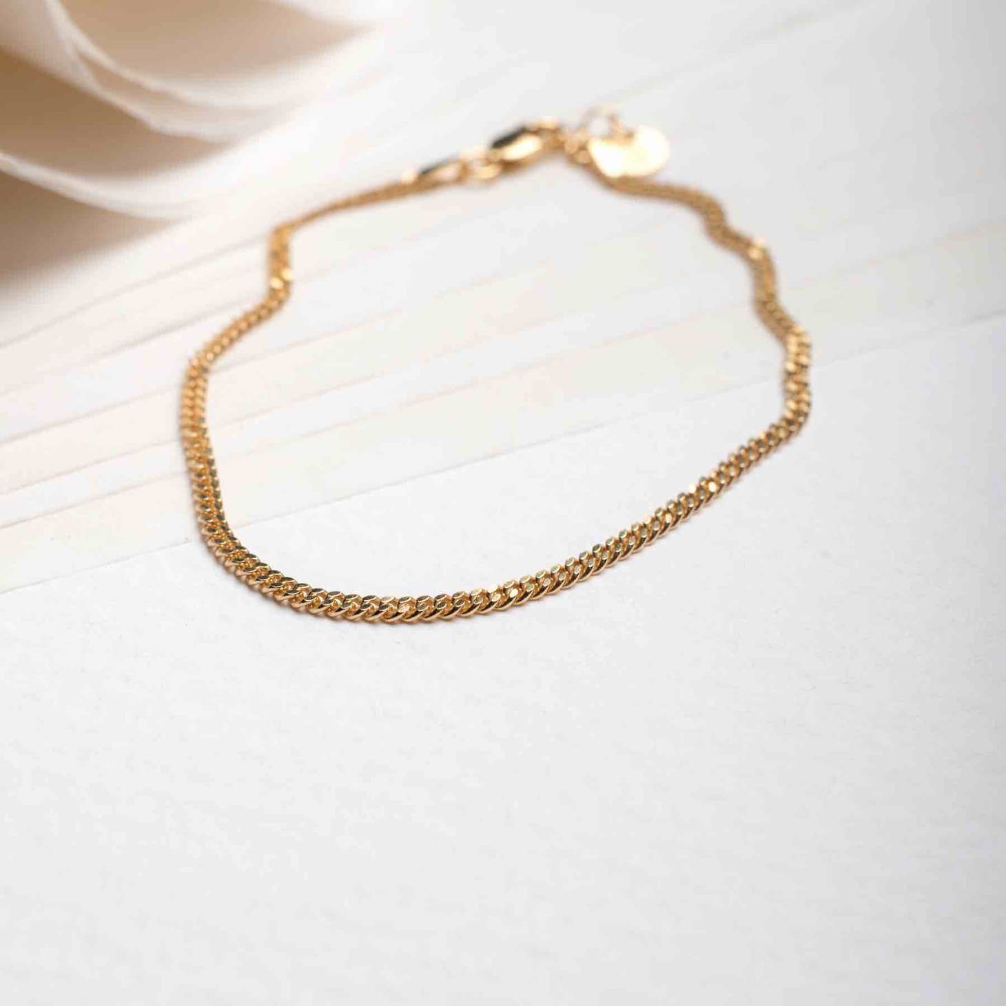 18k gold plated men's bracelet displayed on a table
