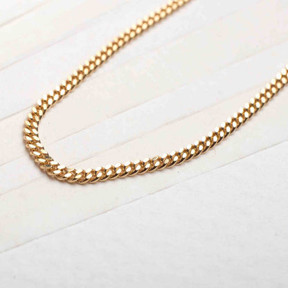 18k men's gold plated necklace displayed on table