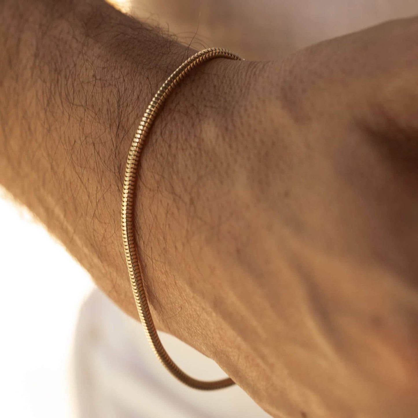 Man modelling a men's 18k gold plated mamba bracelet